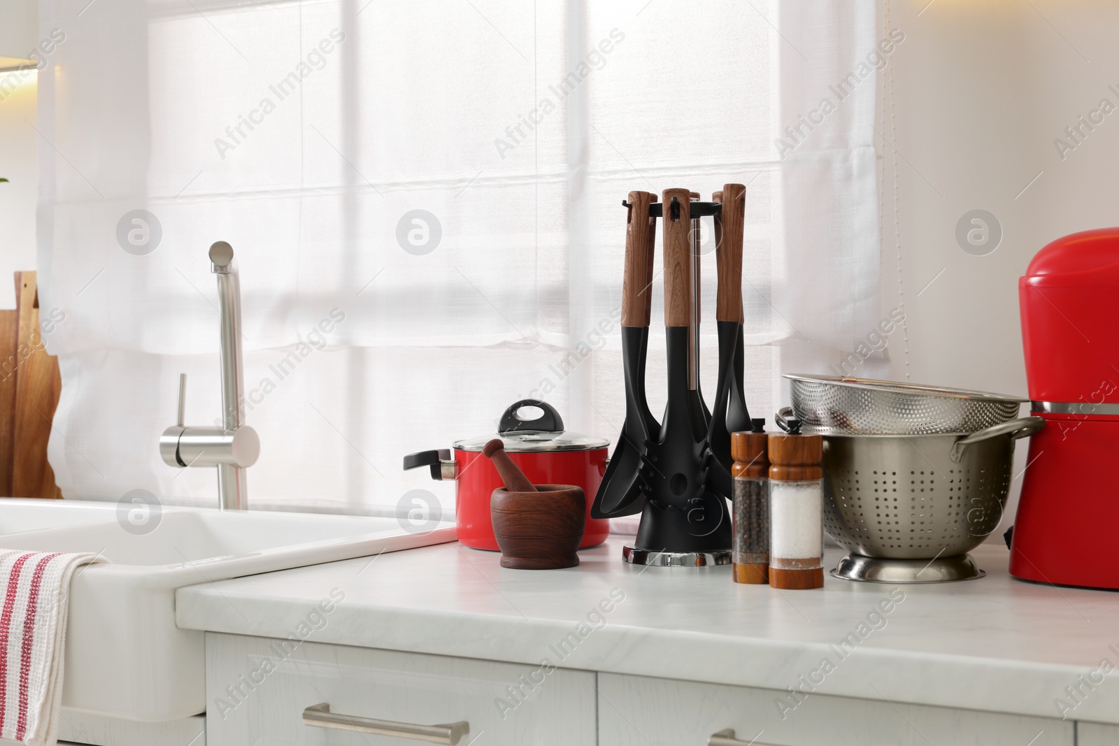 Photo of Set of different utensils on countertop in kitchen