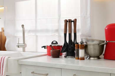 Set of different utensils on countertop in kitchen