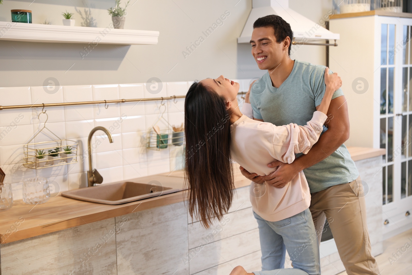 Photo of Lovely young interracial couple dancing at home