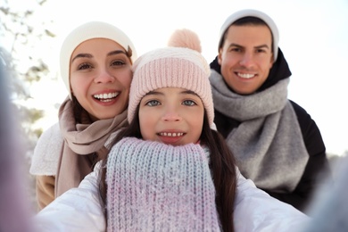 Photo of Happy family taking selfie outdoors on winter day. Christmas vacation