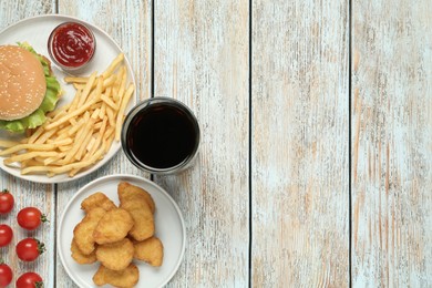 Photo of Flat lay composition with delicious fast food menu on white wooden table. Space for text