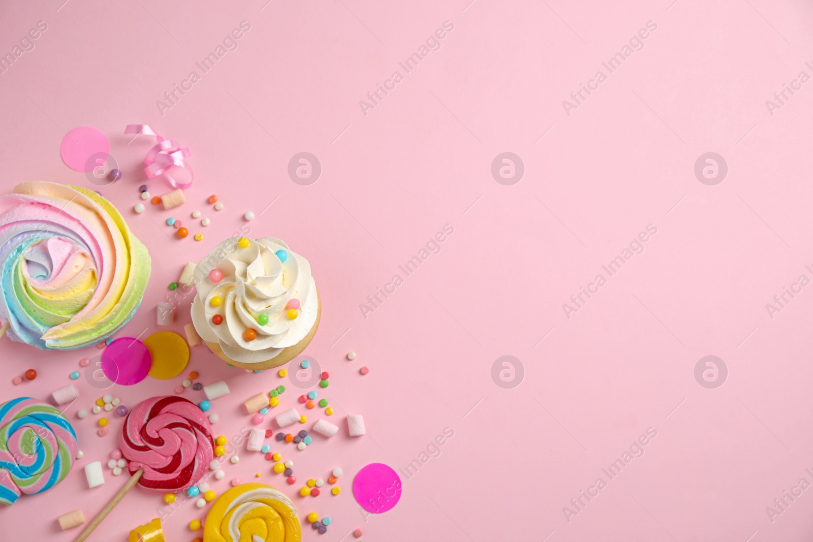 Photo of Flat lay composition with cupcake on pink background, space for text. Birthday party