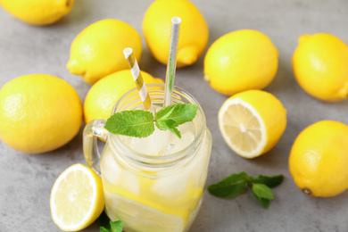 Natural freshly made lemonade and mint on light grey table, closeup. Summer refreshing drink