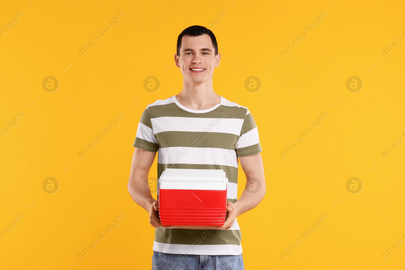 Photo of Man with red cool box on orange background