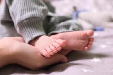 Mother and her newborn baby on bed, closeup. Space for text