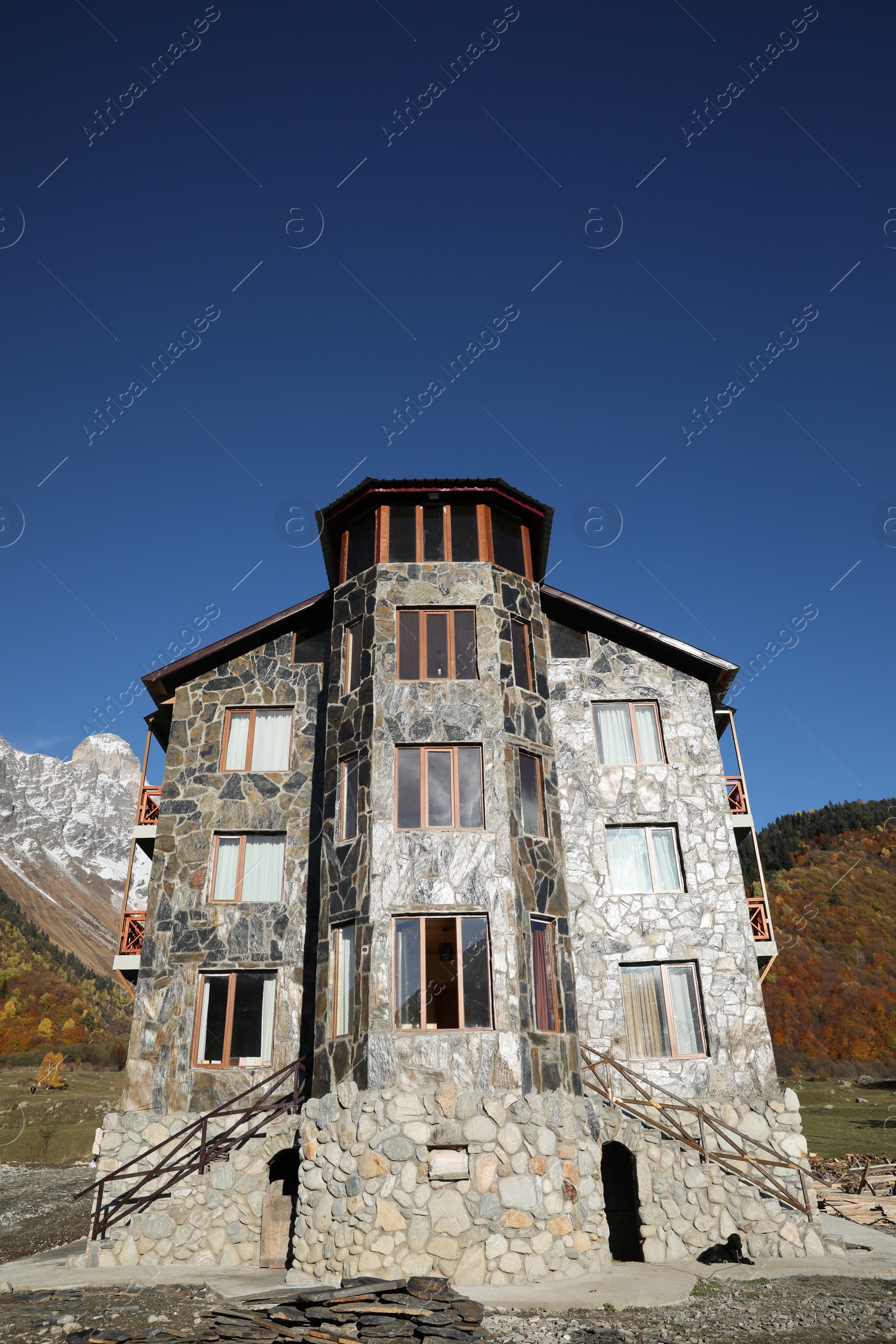 Photo of Exterior of beautiful building with stone fragments against blue sky, low angle view