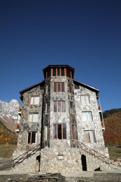 Exterior of beautiful building with stone fragments against blue sky, low angle view