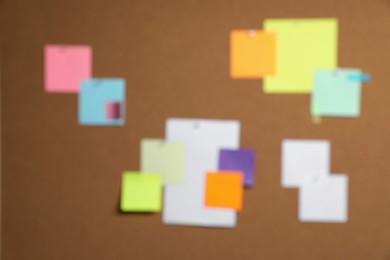 Photo of Blurred view of cork board with many colorful notes
