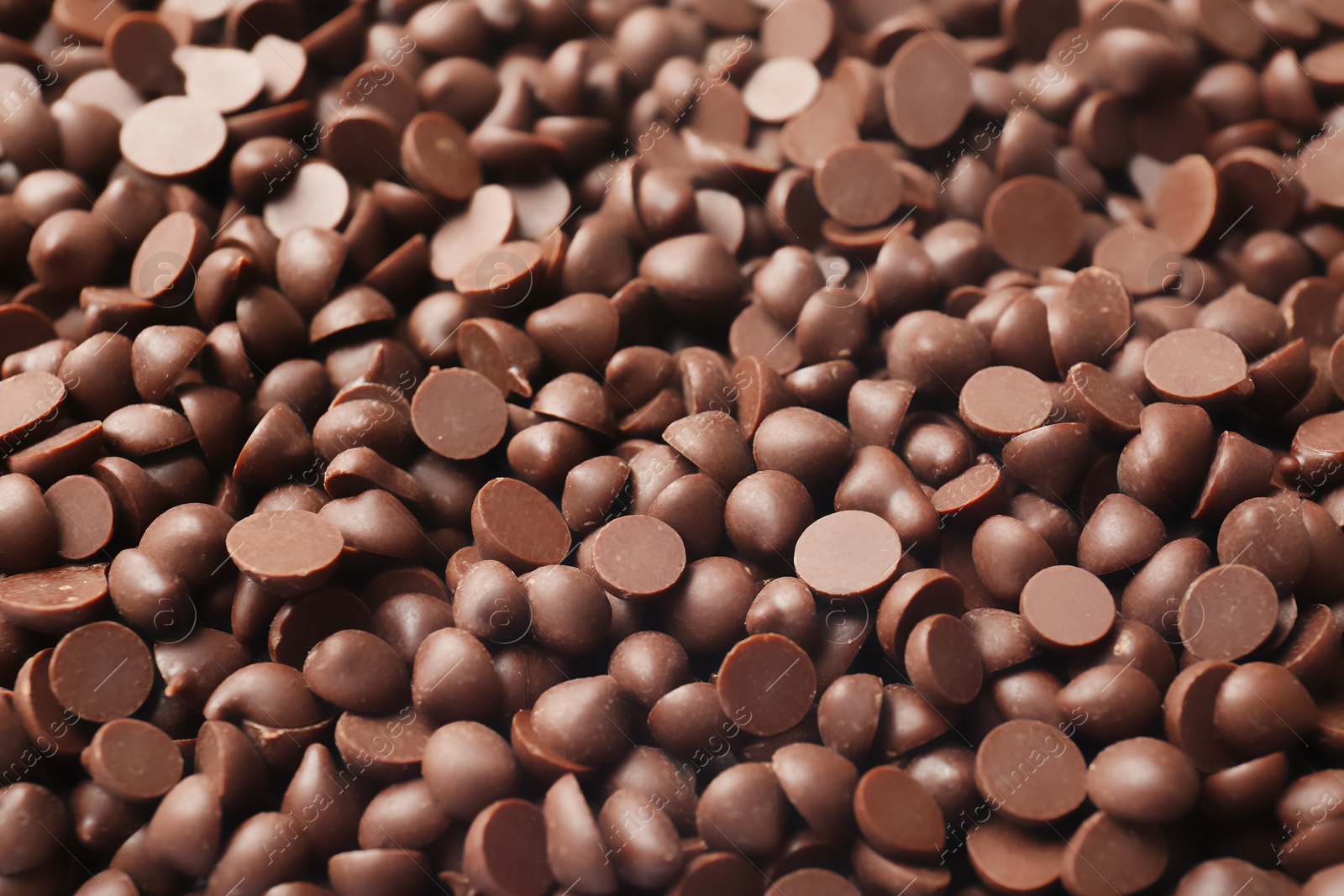 Photo of Many delicious milk chocolate chips, closeup