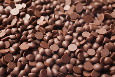 Photo of Many delicious milk chocolate chips, closeup