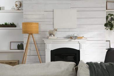 Photo of Stylish living room interior with empty canvas on white wooden wall. Mockup for design