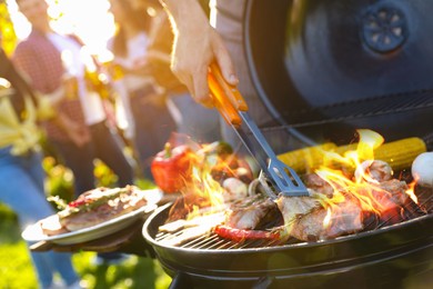 Photo of Group of friends having barbecue party outdoors, closeup