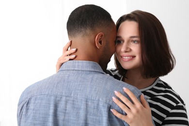 Photo of Dating agency. Woman hugging her boyfriend on white background