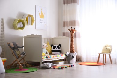 Baby room interior with stylish furniture and toys