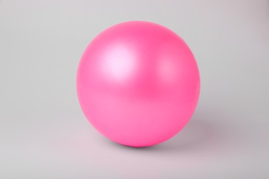 Photo of Pink inflatable beach ball on white background
