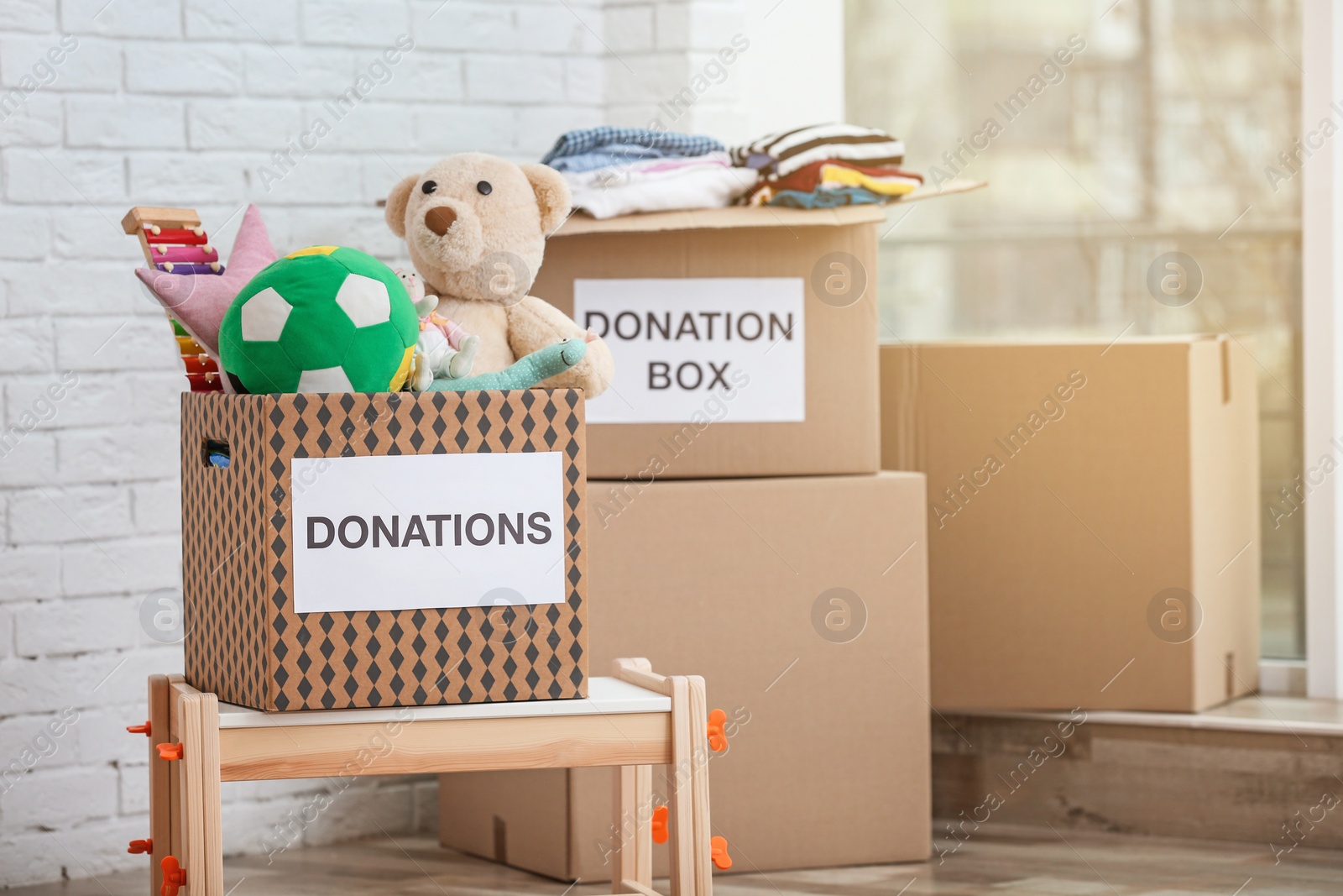 Photo of Donation boxes with toys and clothes indoors