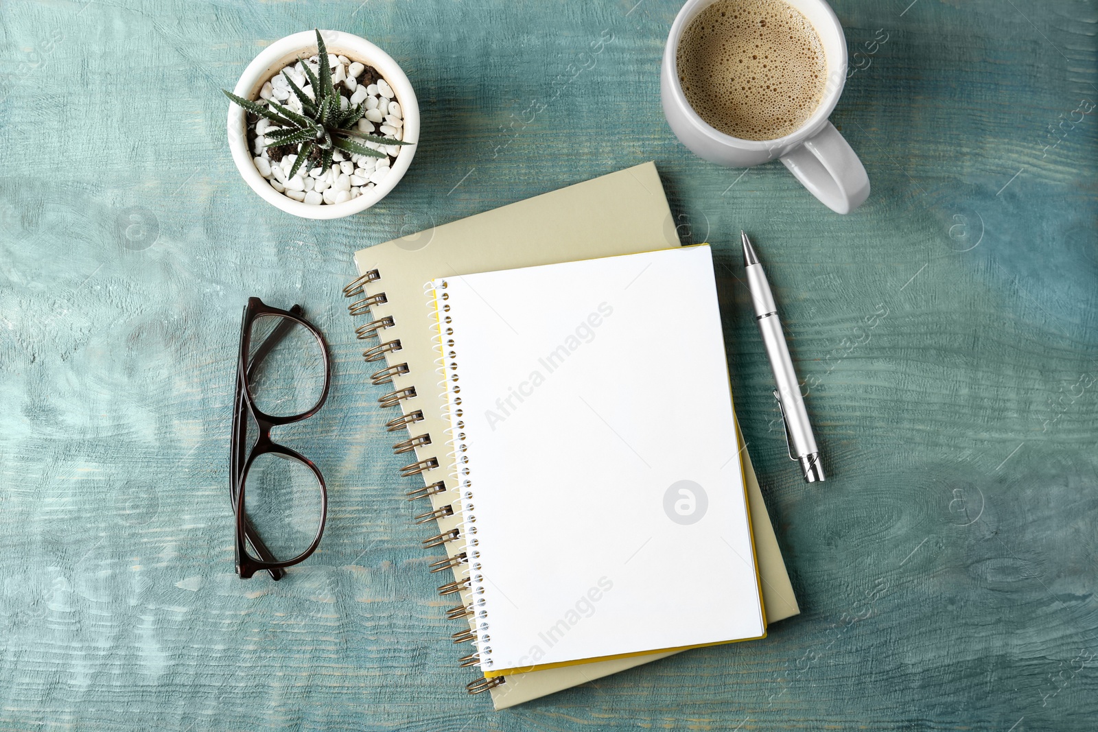 Photo of Flat lay composition with office stationery and cup of coffee on wooden table. Space for design