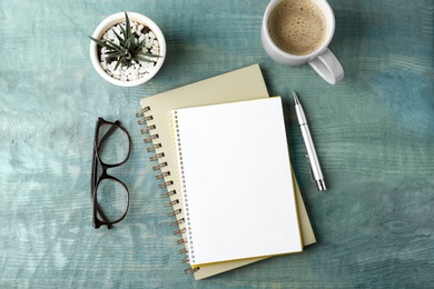 Photo of Flat lay composition with office stationery and cup of coffee on wooden table. Space for design