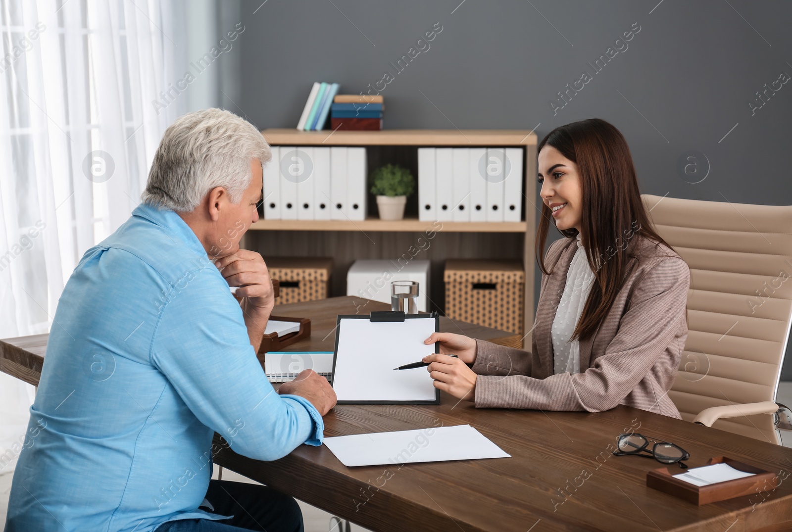 Photo of Lawyer having meeting with senior client in office