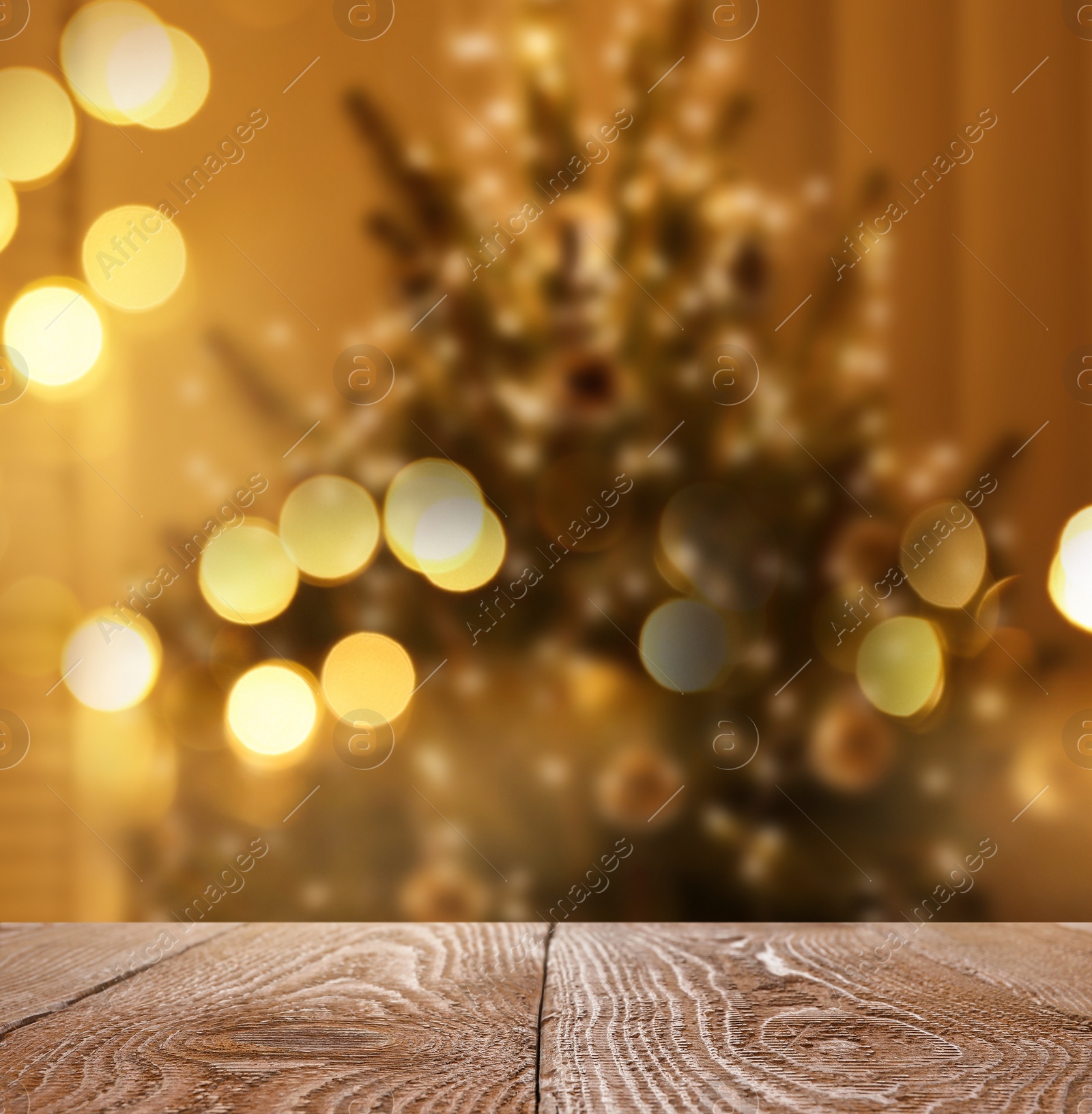 Image of Empty wooden surface and blurred view of Christmas tree in room, space for text. Interior design