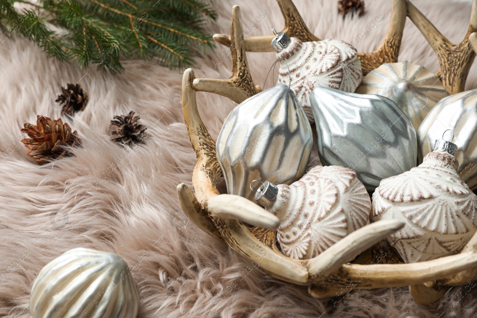 Photo of Composition with beautiful Christmas baubles on beige fur