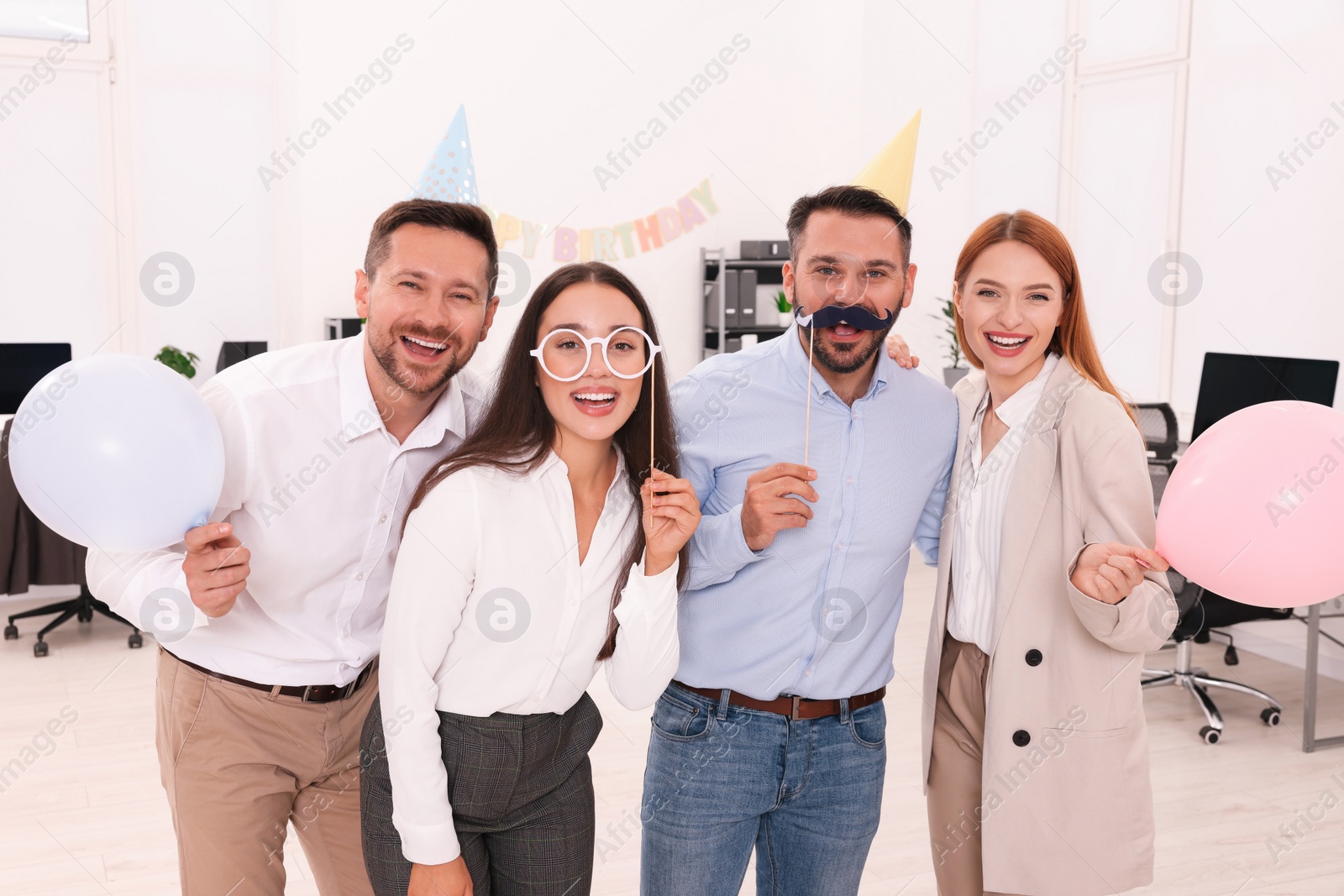 Photo of Coworkers having fun during office party indoors