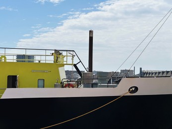 Ships moored in sea port on sunny day