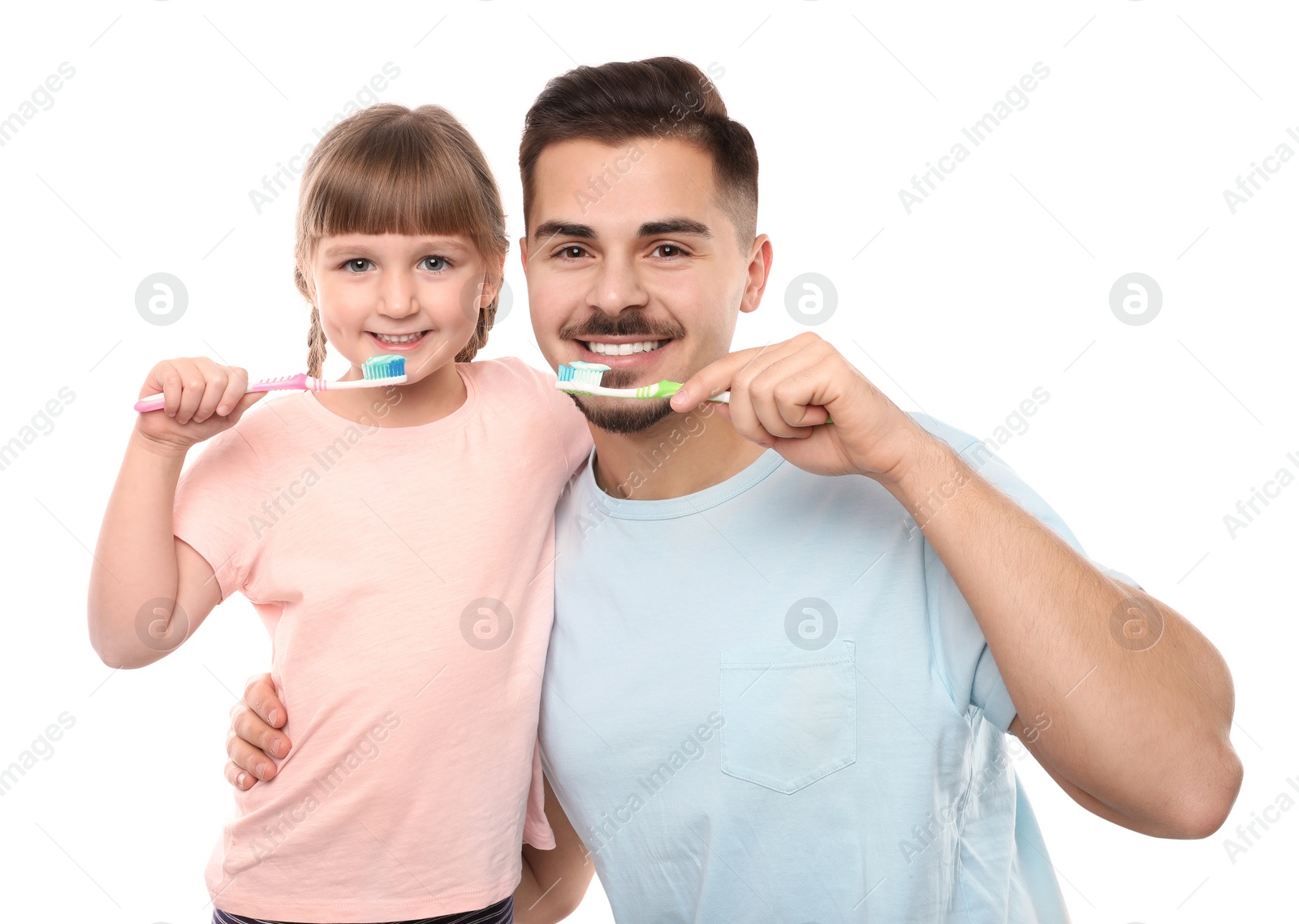 Photo of Little girl and her father brushing teeth together on white background