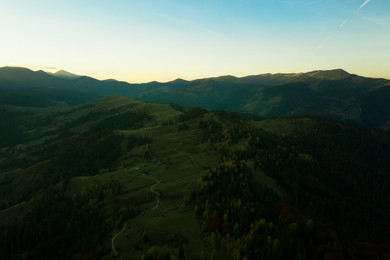 Aerial view of beautiful mountain landscape with village at sunrise