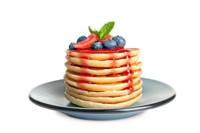 Photo of Plate with pancakes and berries on white background