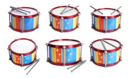 Image of Bright toy drums and sticks on white background, set