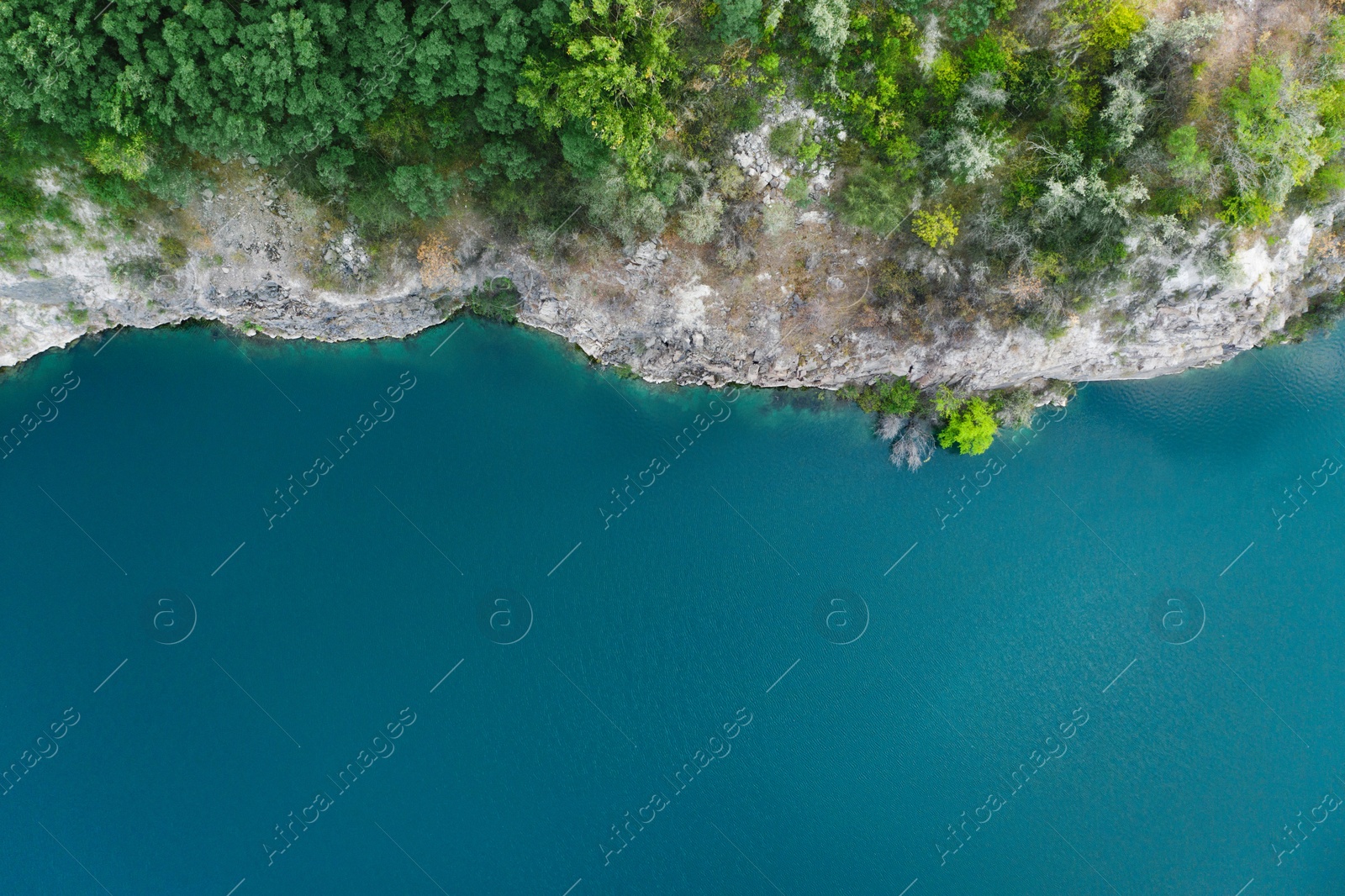 Image of Beautiful blue lake with granite bank, top view