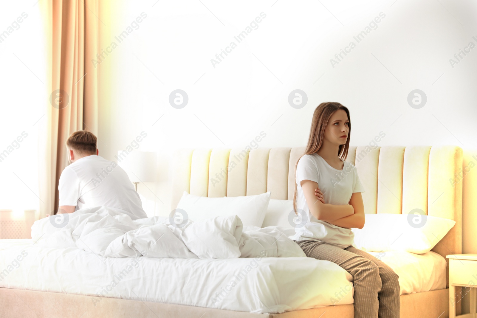 Image of Unhappy young couple with relationship problems at home. Cheating and breakup