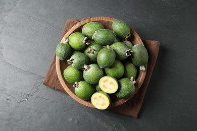 Photo of Delicious fresh feijoas on black table, top view