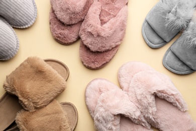 Photo of Different soft slippers on beige background, flat lay