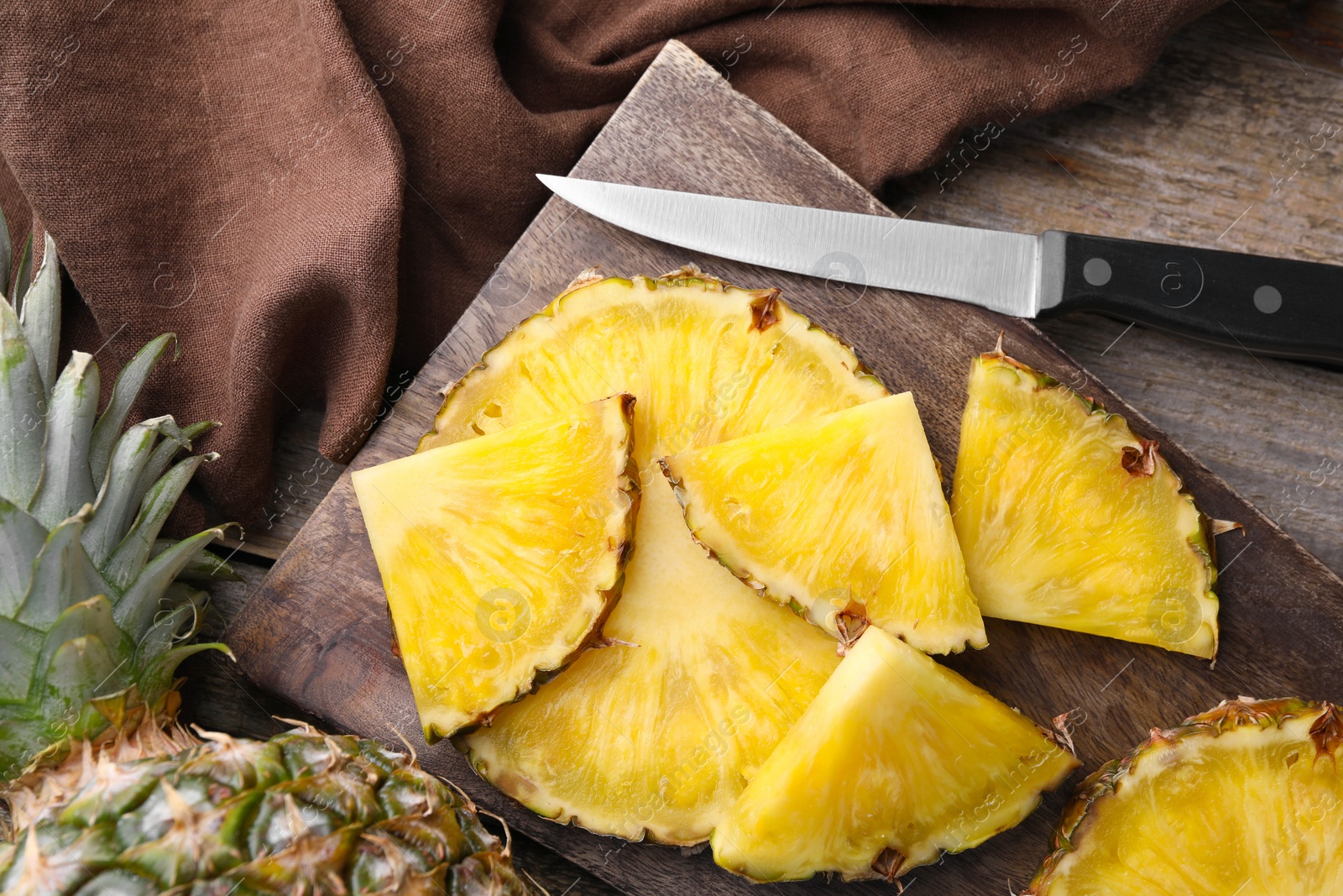 Photo of Pieces of tasty ripe pineapple on table, flat lay