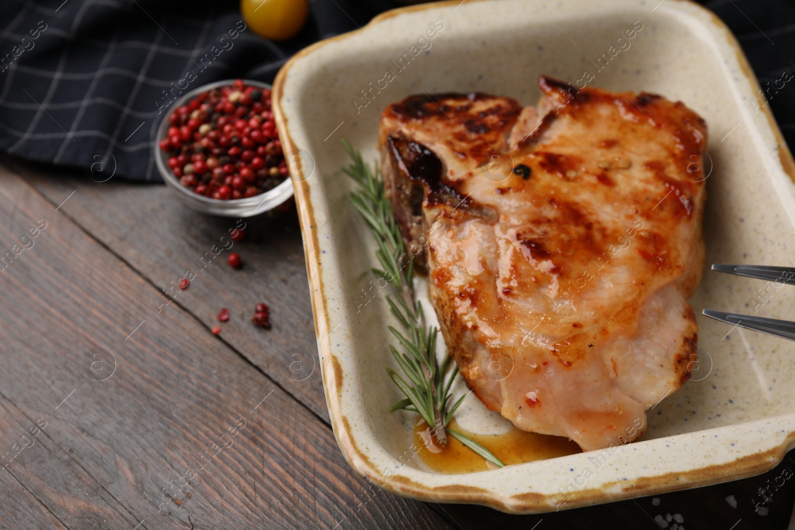 Photo of Tasty marinated meat, rosemary and peppercorns on wooden table, closeup. Space for text