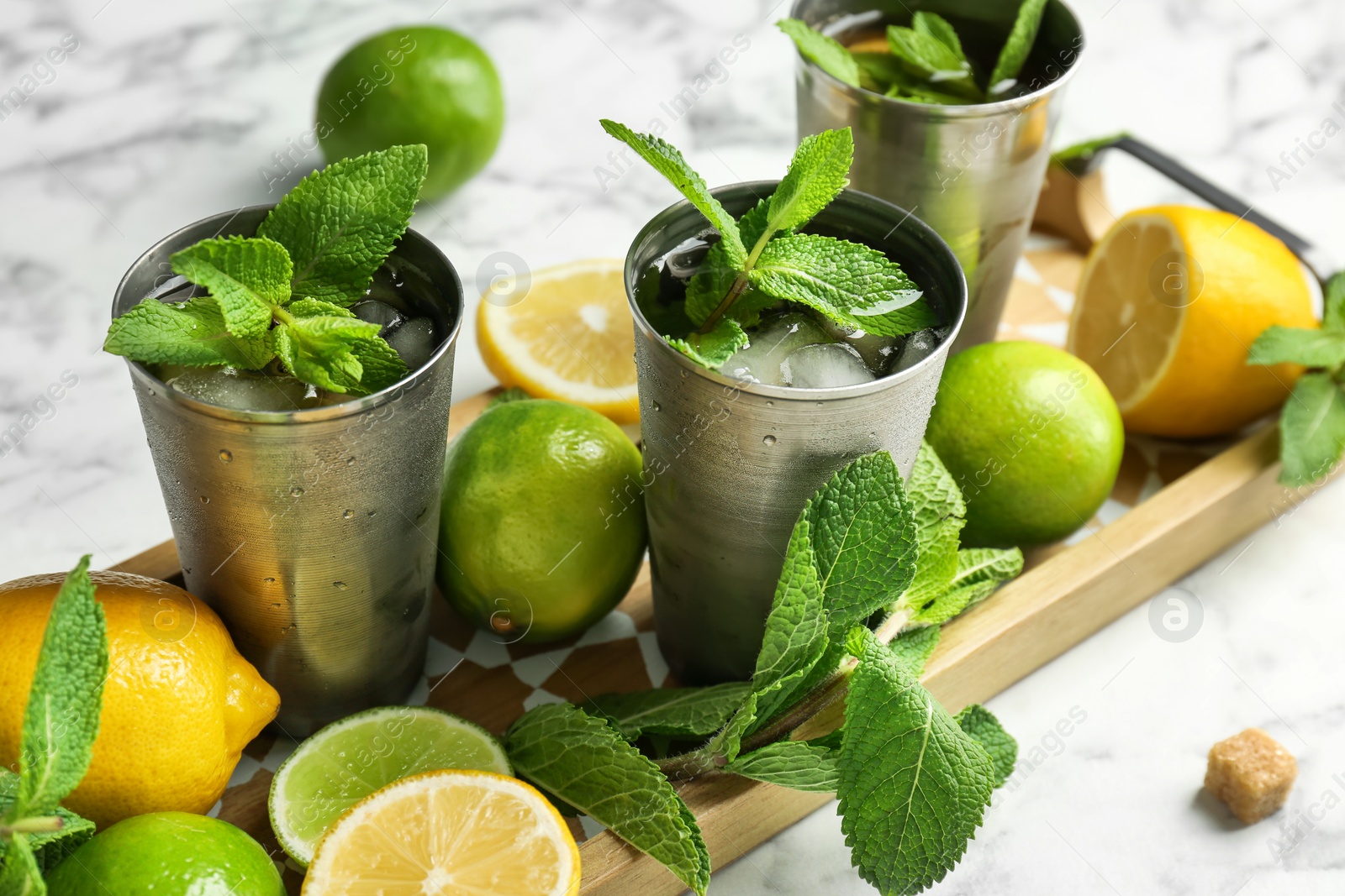 Photo of Composition with delicious mint julep cocktail on table