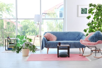 Photo of Elegant living room interior with rocking chair and cozy sofa