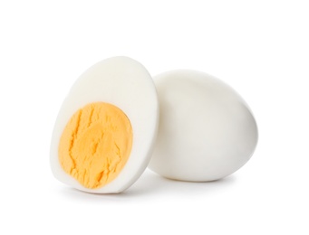 Sliced and whole hard boiled eggs on white background