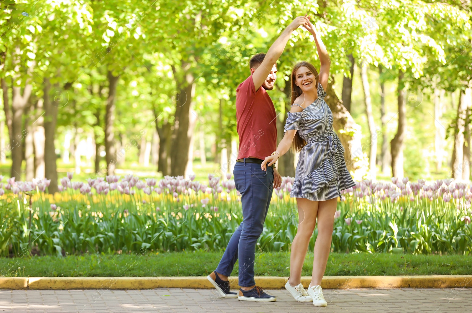 Photo of Happy young couple in green park on sunny spring day