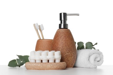 Bath accessories. Different personal care products and eucalyptus branches on table against white background