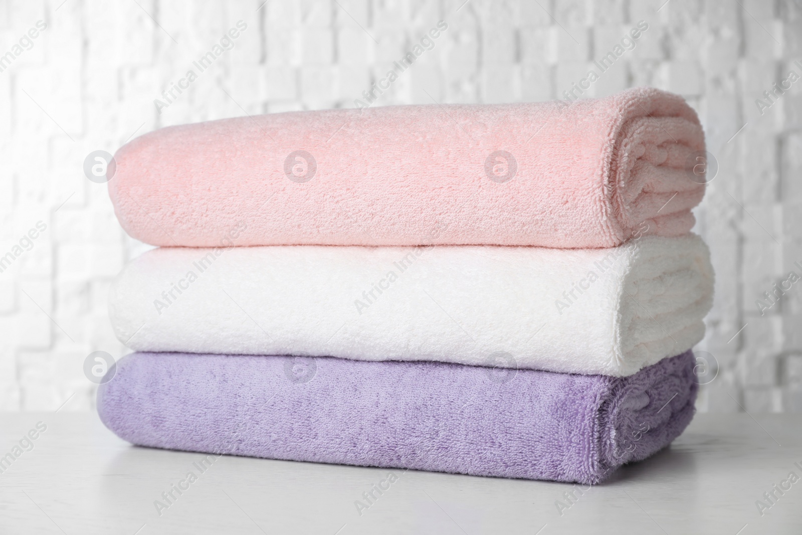 Photo of Stack of soft bath towels on table