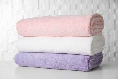 Stack of soft bath towels on table