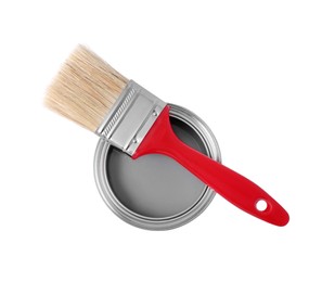 Photo of Can with gray paint and brush on white background, top view