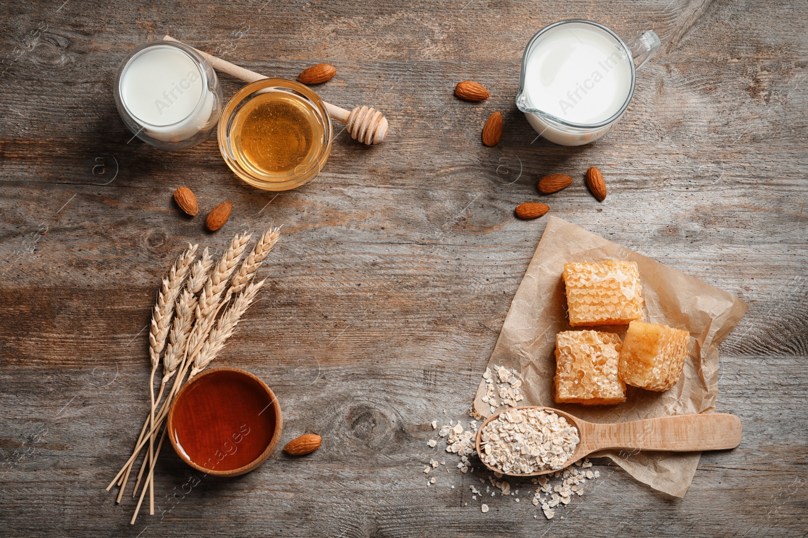 Photo of Beautiful composition with milk and honey on wooden background