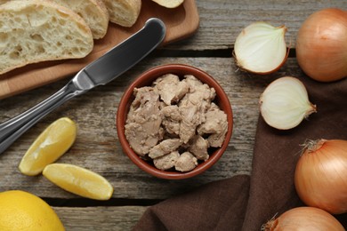 Flat lay composition with tasty cod liver and different products on wooden table