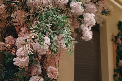 Building decorated with beautiful pink flowers, closeup