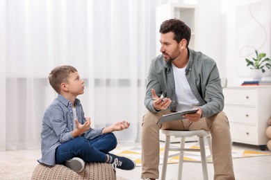 Dyslexia treatment. Therapist working with boy in room