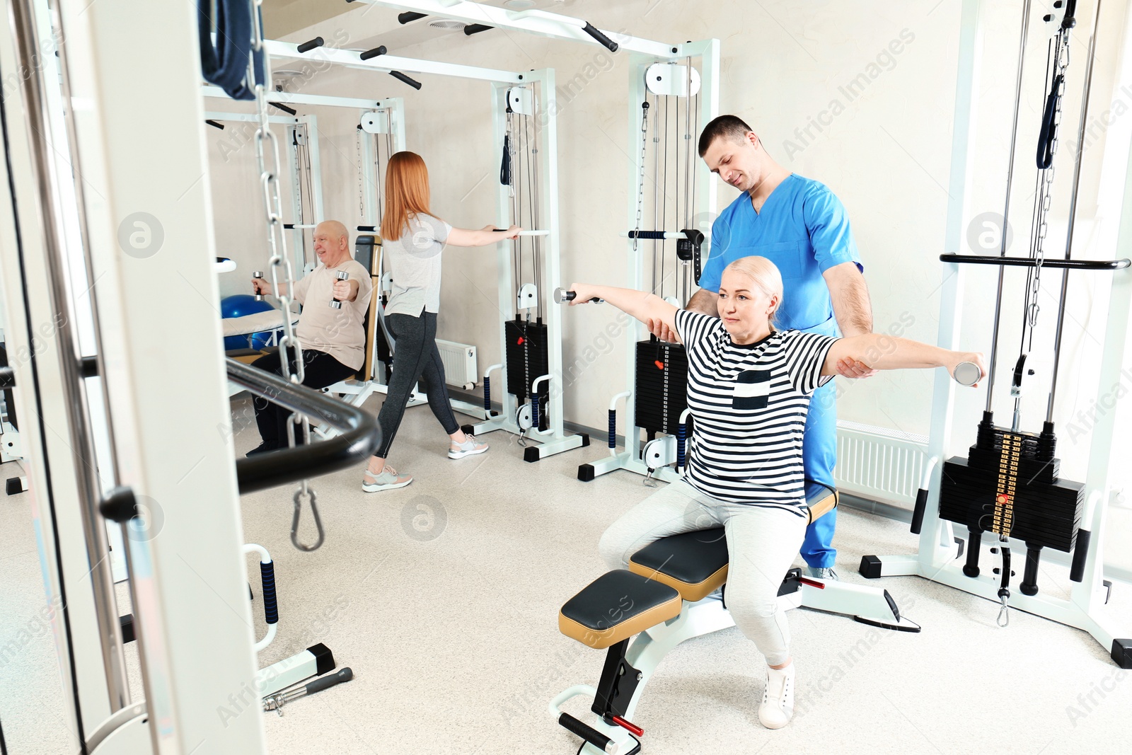 Photo of Patient exercising under physiotherapist supervision in rehabilitation center